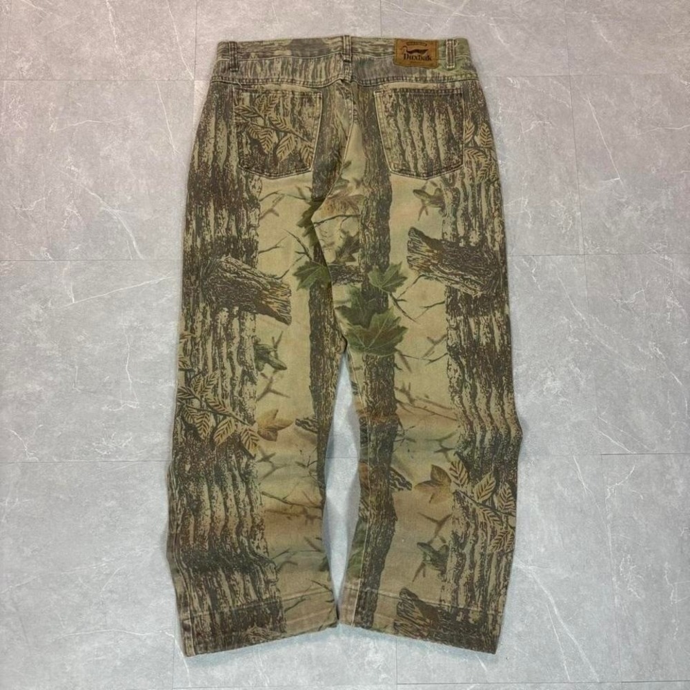 90's Brown and tan camouflage jeans with a distressed look